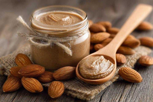 Homemade almond butter in a glass jar with whole almonds