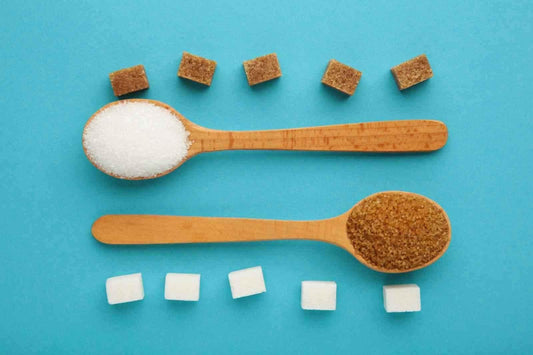 Jaggery vs sugar comparison - white sugar and brown jaggery shown side by side