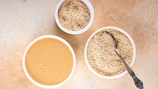 Hulled and unhulled sesame seeds arranged in bowls to illustrate different uses in tahini, baking and everyday cooking.