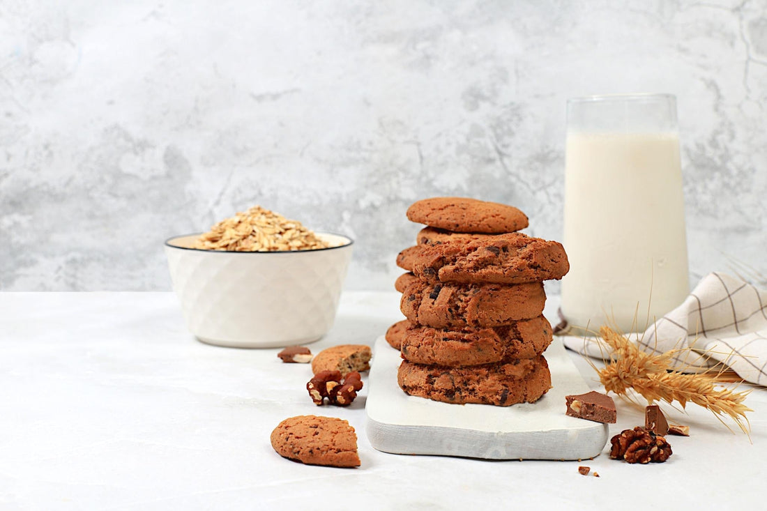 Stack of healthy cookies with oats and milk, illustrating a healthier cookie snack option